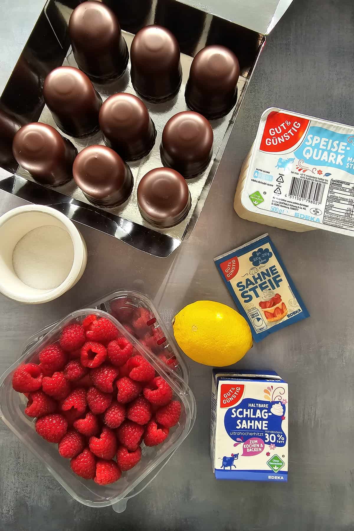 A compilation of the ingredients for Dickmann's dessert with raspberries.