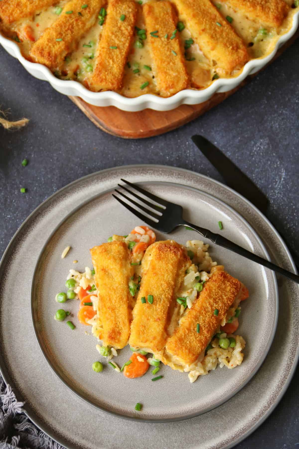 A plate of fish sticks casserole. Top part of a round baking dish with the dish.