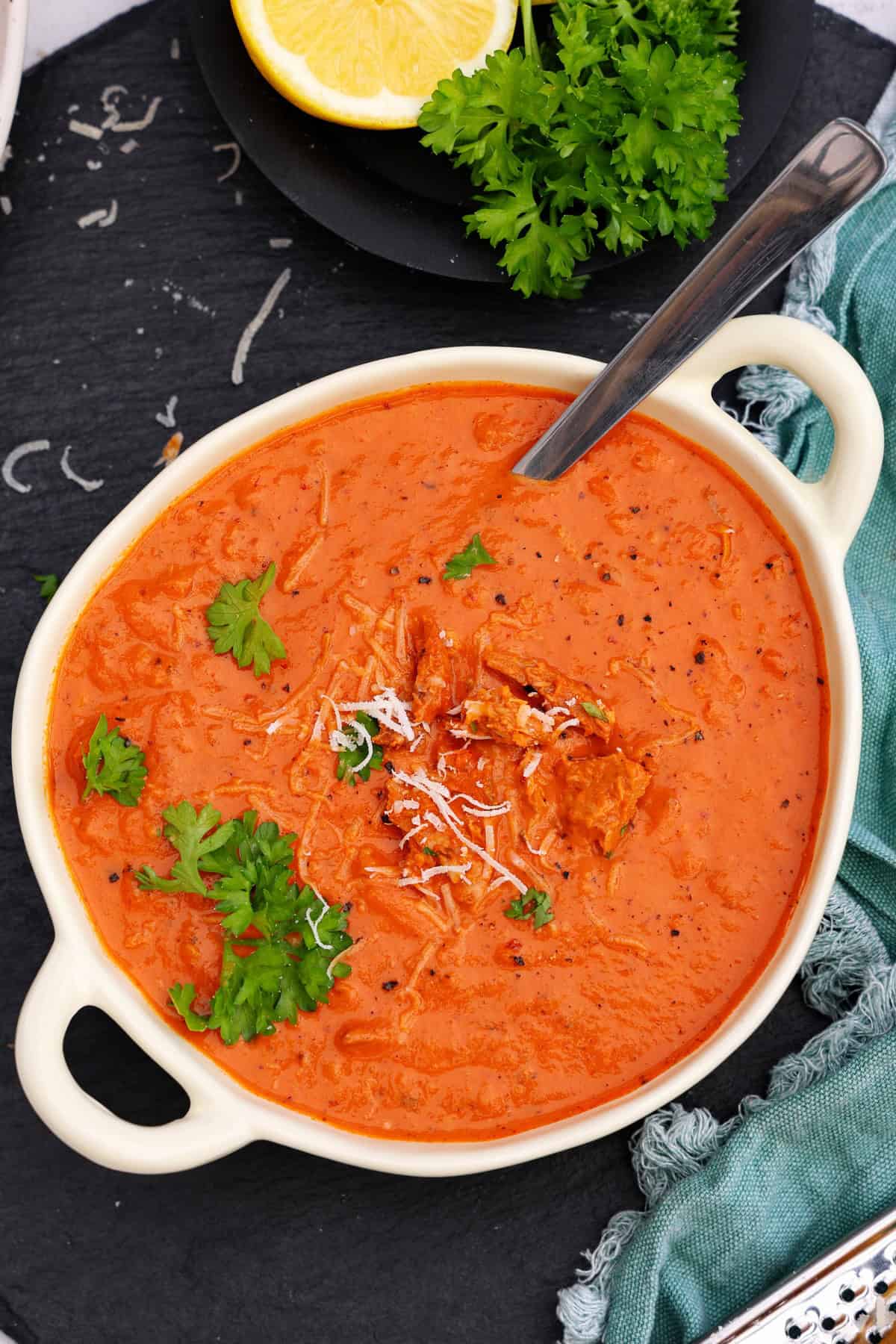 A white bowl of tuna and tomato sauce for pasta .