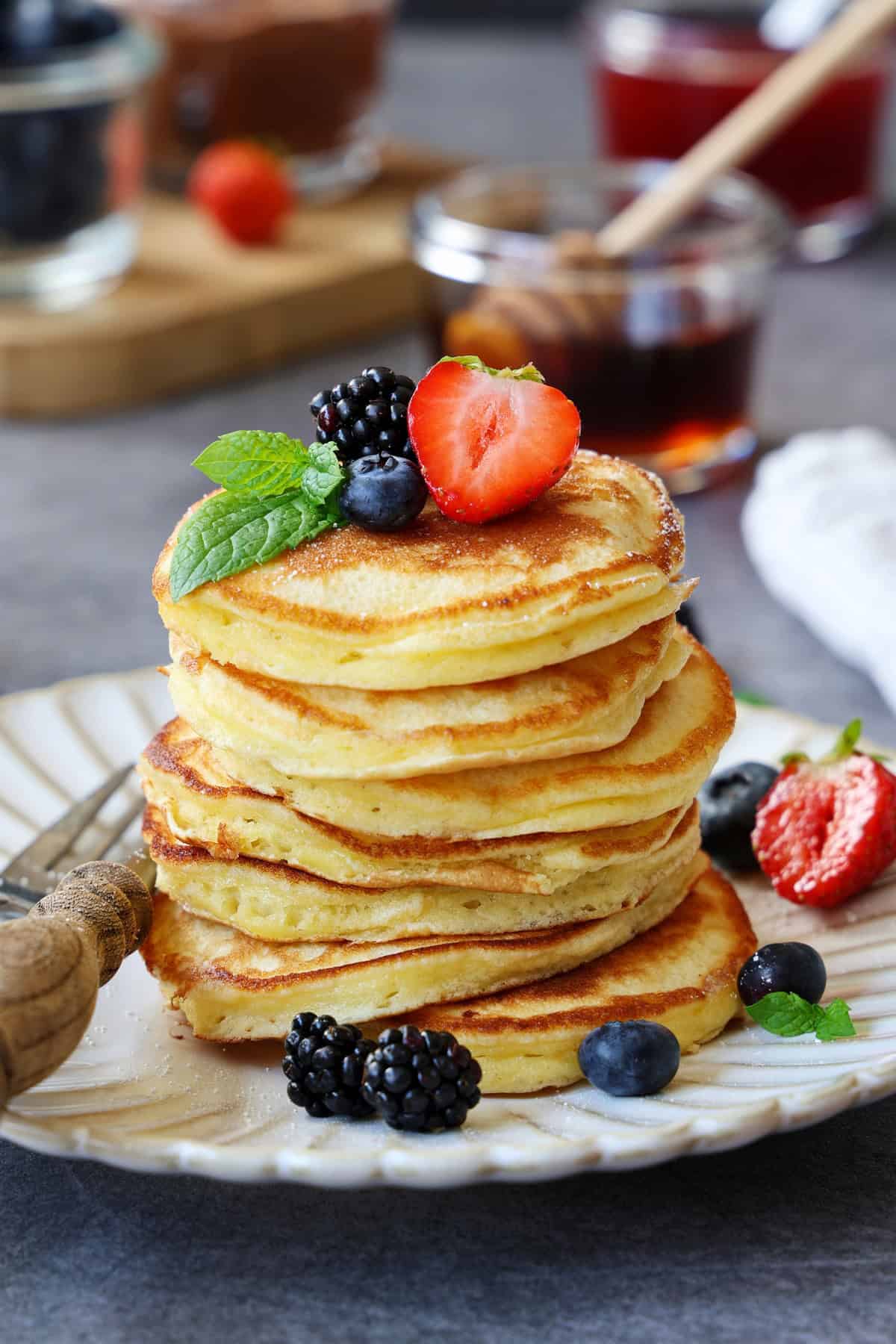 Ein Stapel Pancakes mit Früchten auf einem Teller.