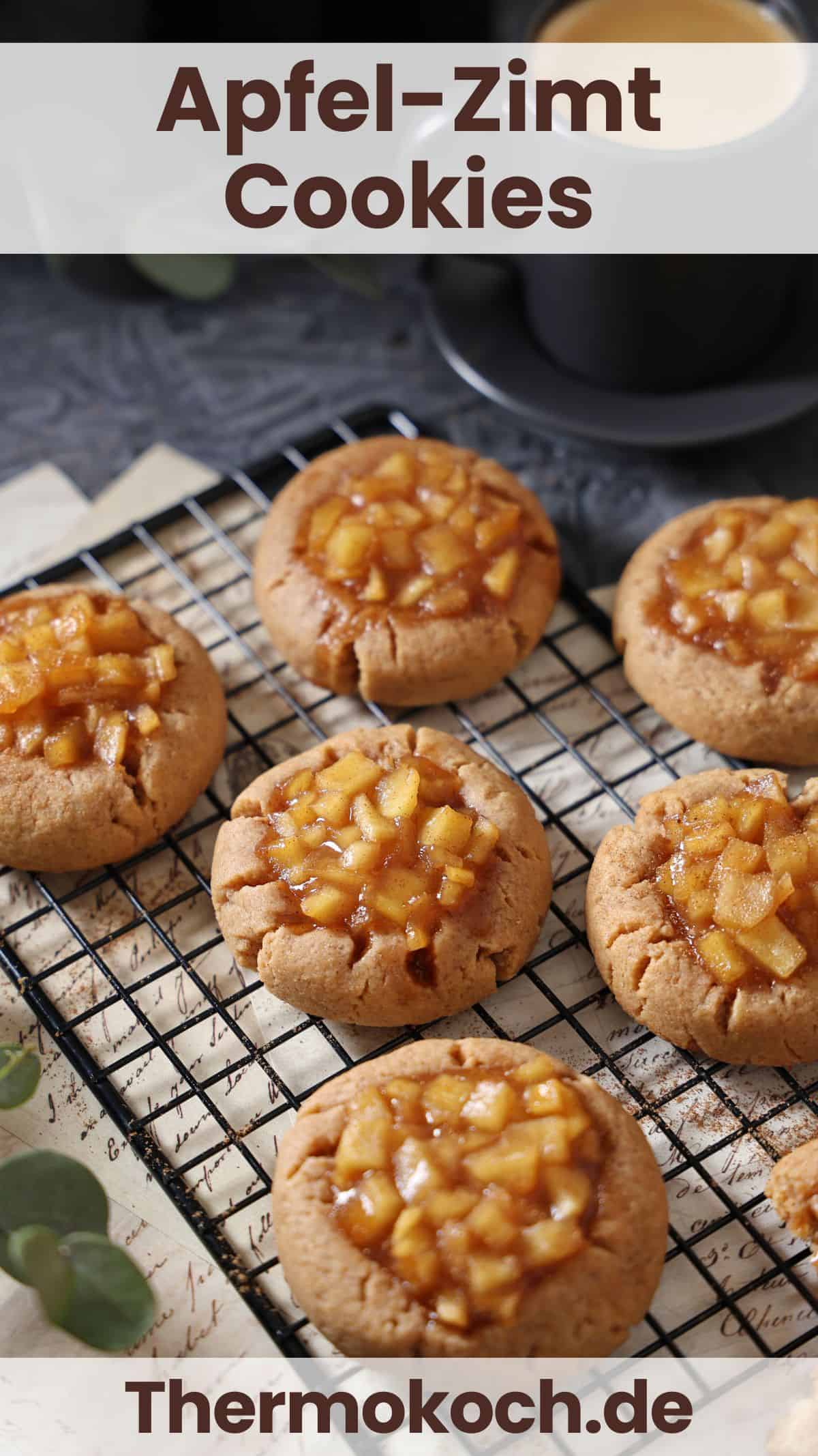 Apple cinnamon cookies on a black wire cooling rack.