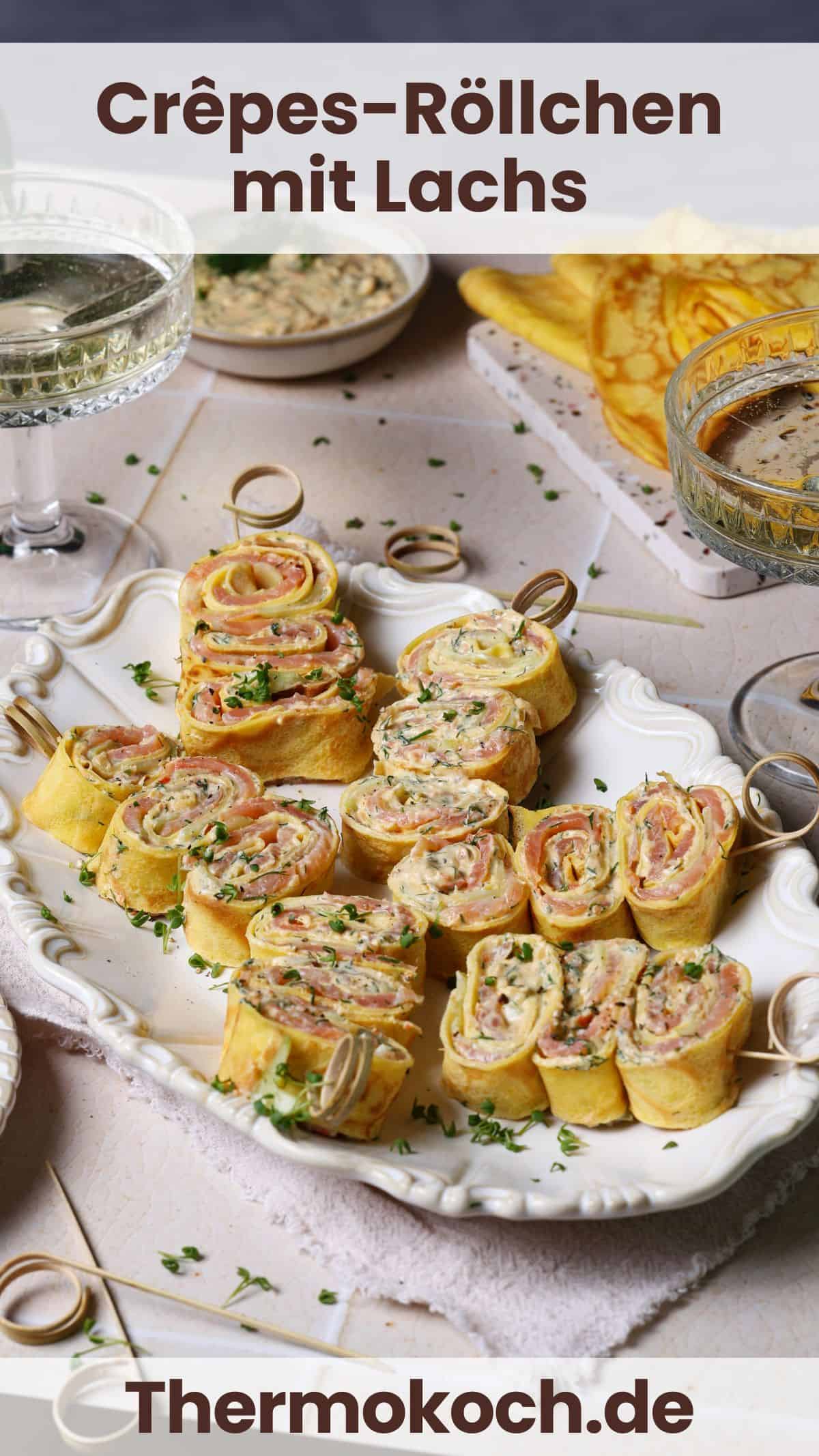 Savory crêpe roll-ups with salmon and dill cream cheese spread on a white serving platter.