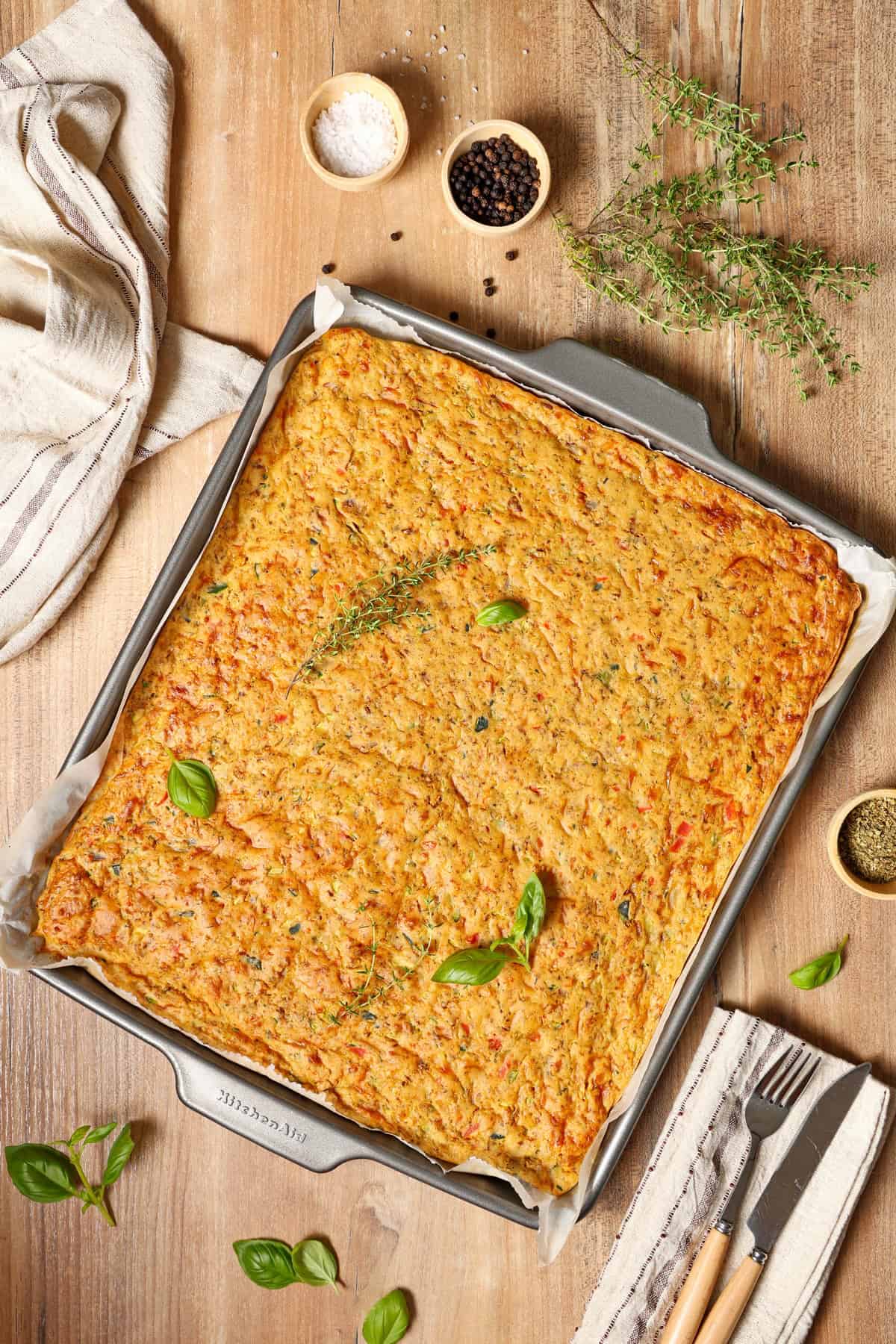 A vegetable quiche in a baking dish.