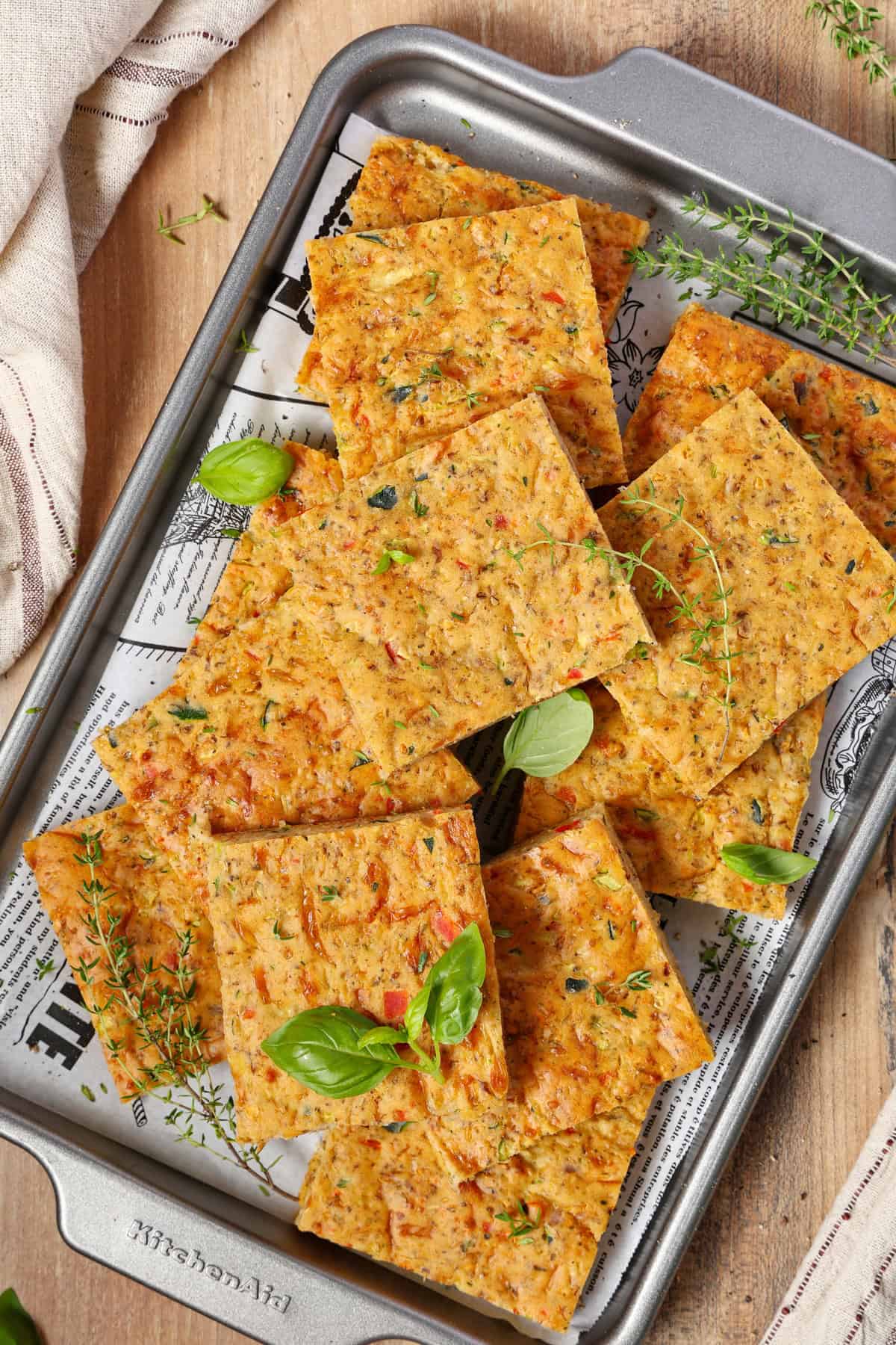 A serving platter with slices of veggie quiche.