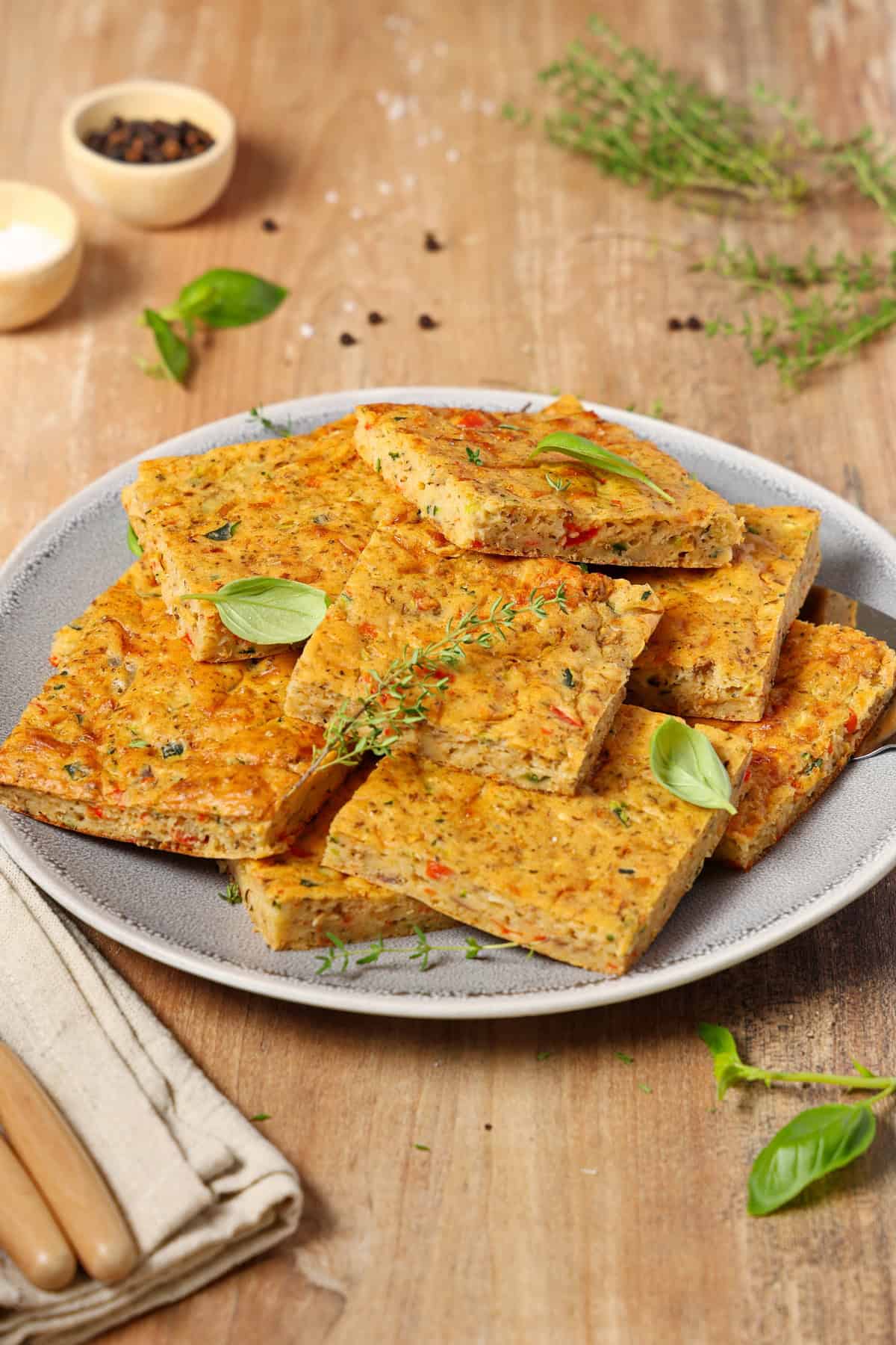 A plate with slices of vegetable quiche.