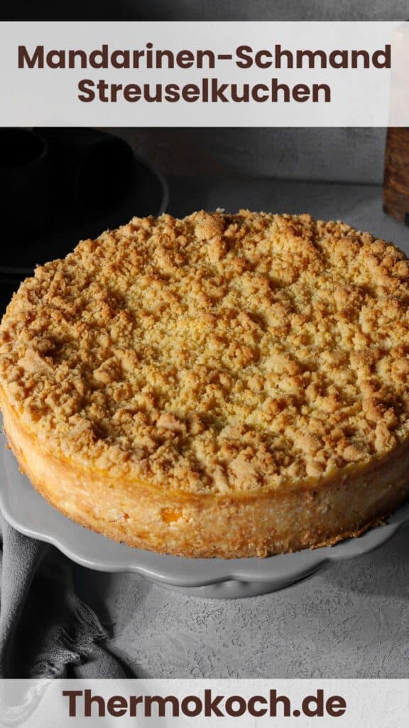 A mandarin orange sour cream streusel cake on a round, white serving tray.