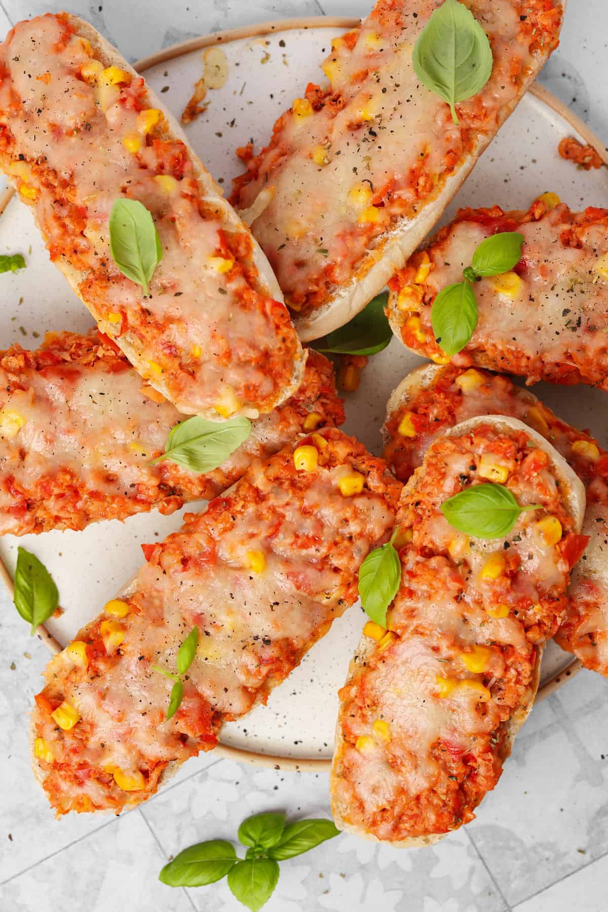 A light-colored plate topped with fresh baked pizza rolls.