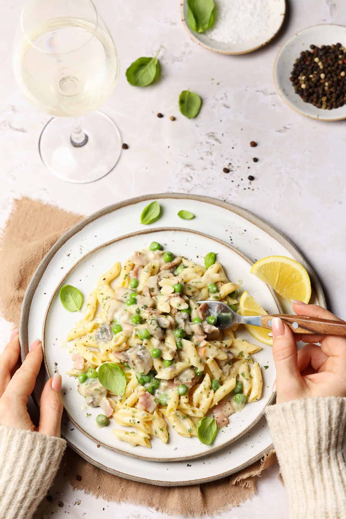 A plate of creamy lemon pasta with mushrooms and peas.