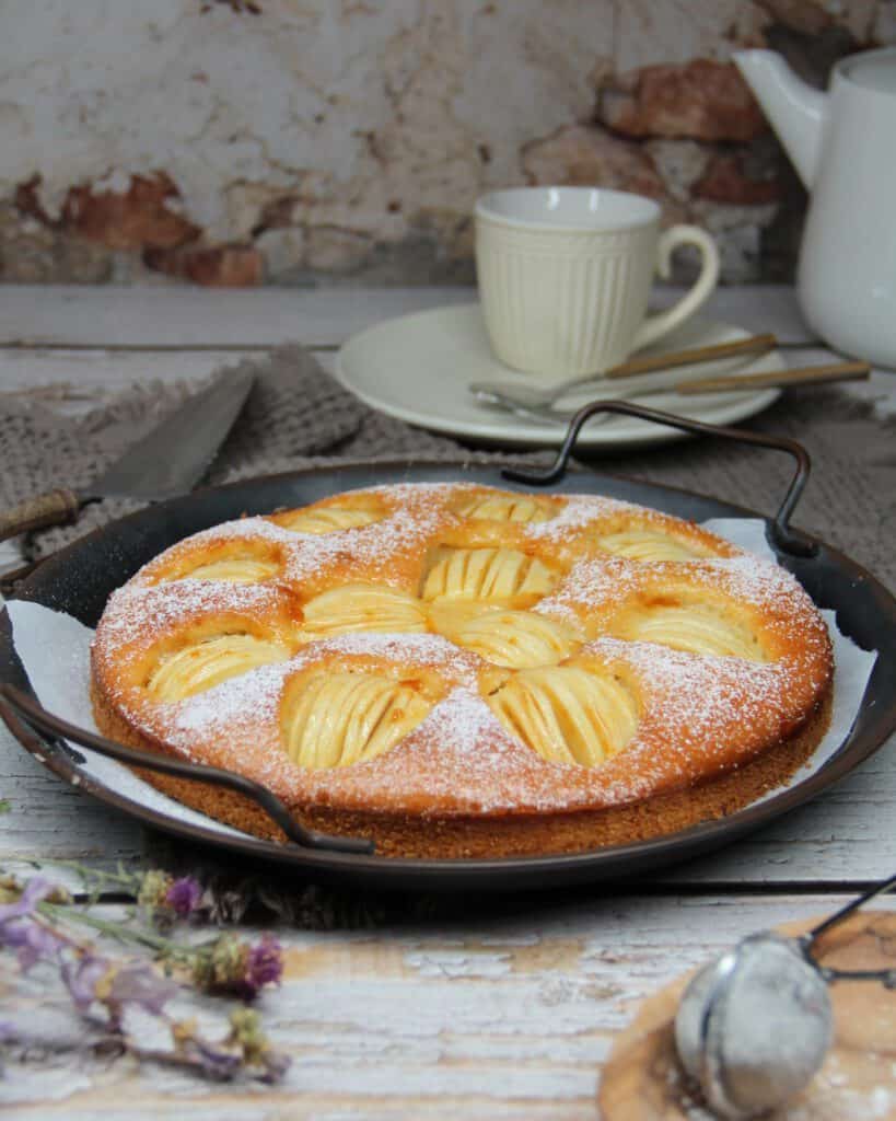 An apple cake on a serving tray.