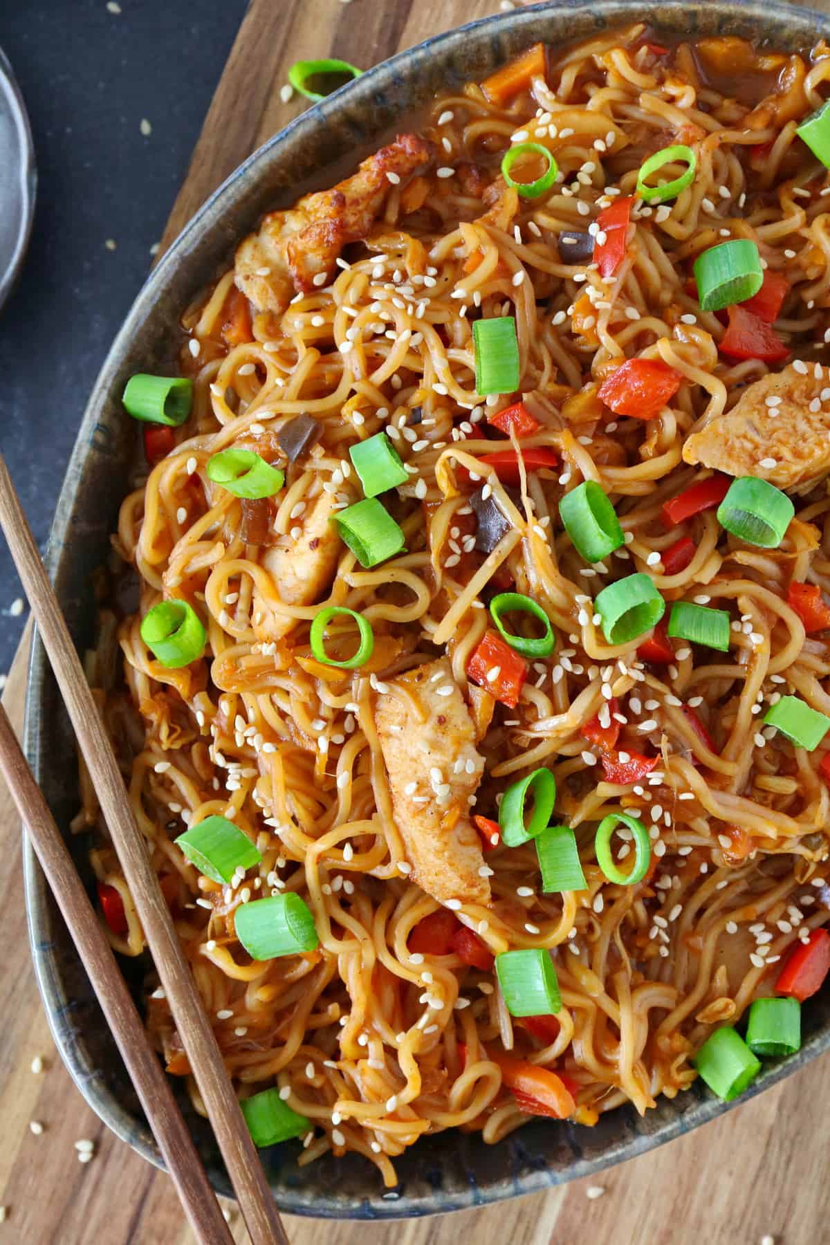 A close-up of a bowl of Asian chicken noodles.
