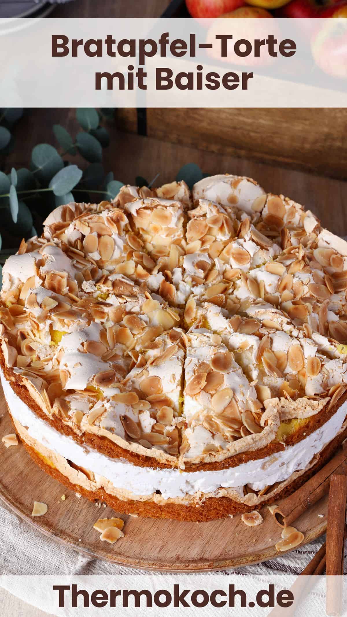 A baked apple cake with meringue on a round wooden serving tray.