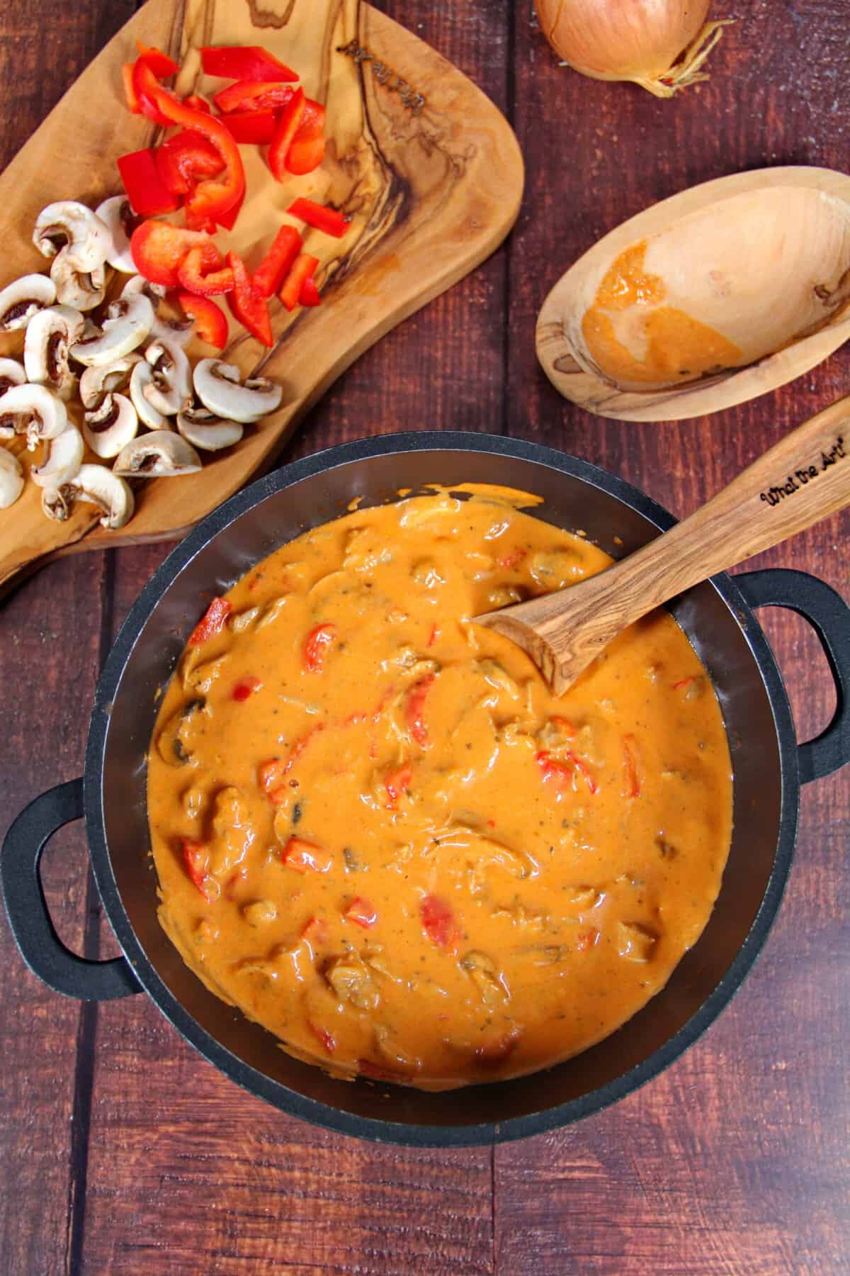 A skillet filled with chicken gyros, bell peppers, and mushrooms.