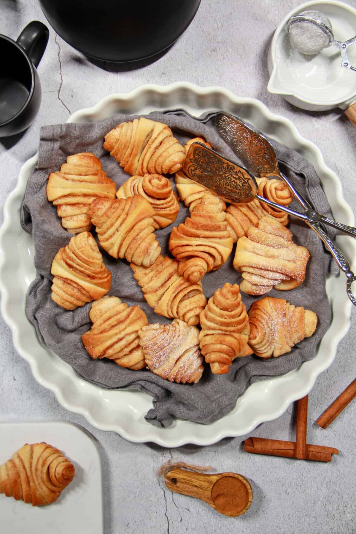 A white round platter filled with mini Franzbrötchen.