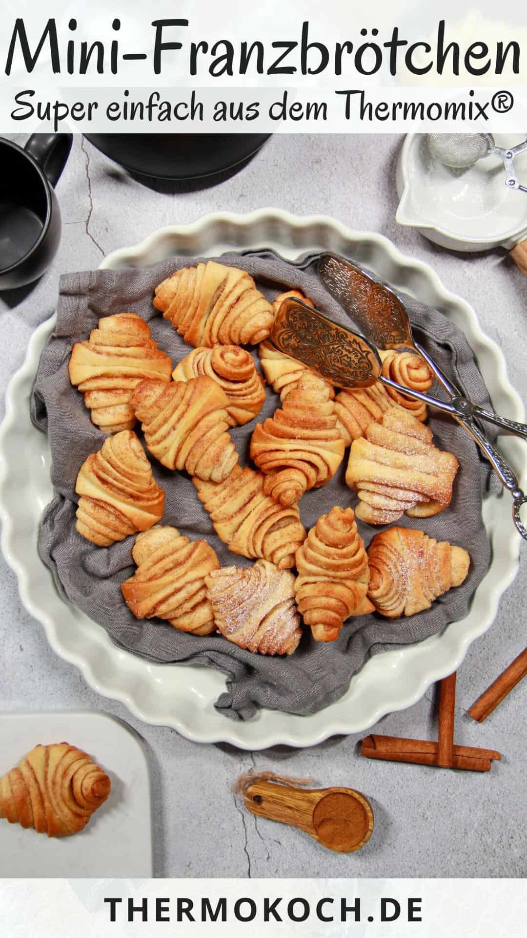 A white round serving platter filled with mini Franzbrötchen.