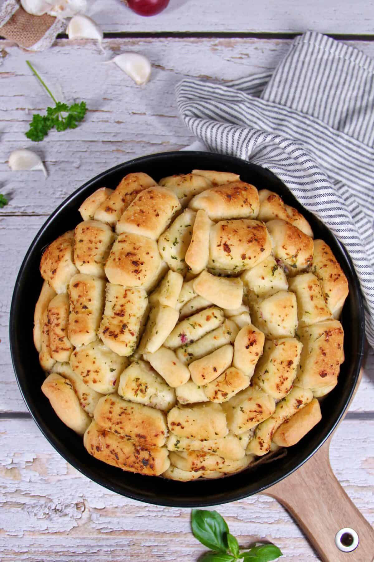 Round herb pull-apart bread in a springform pan.