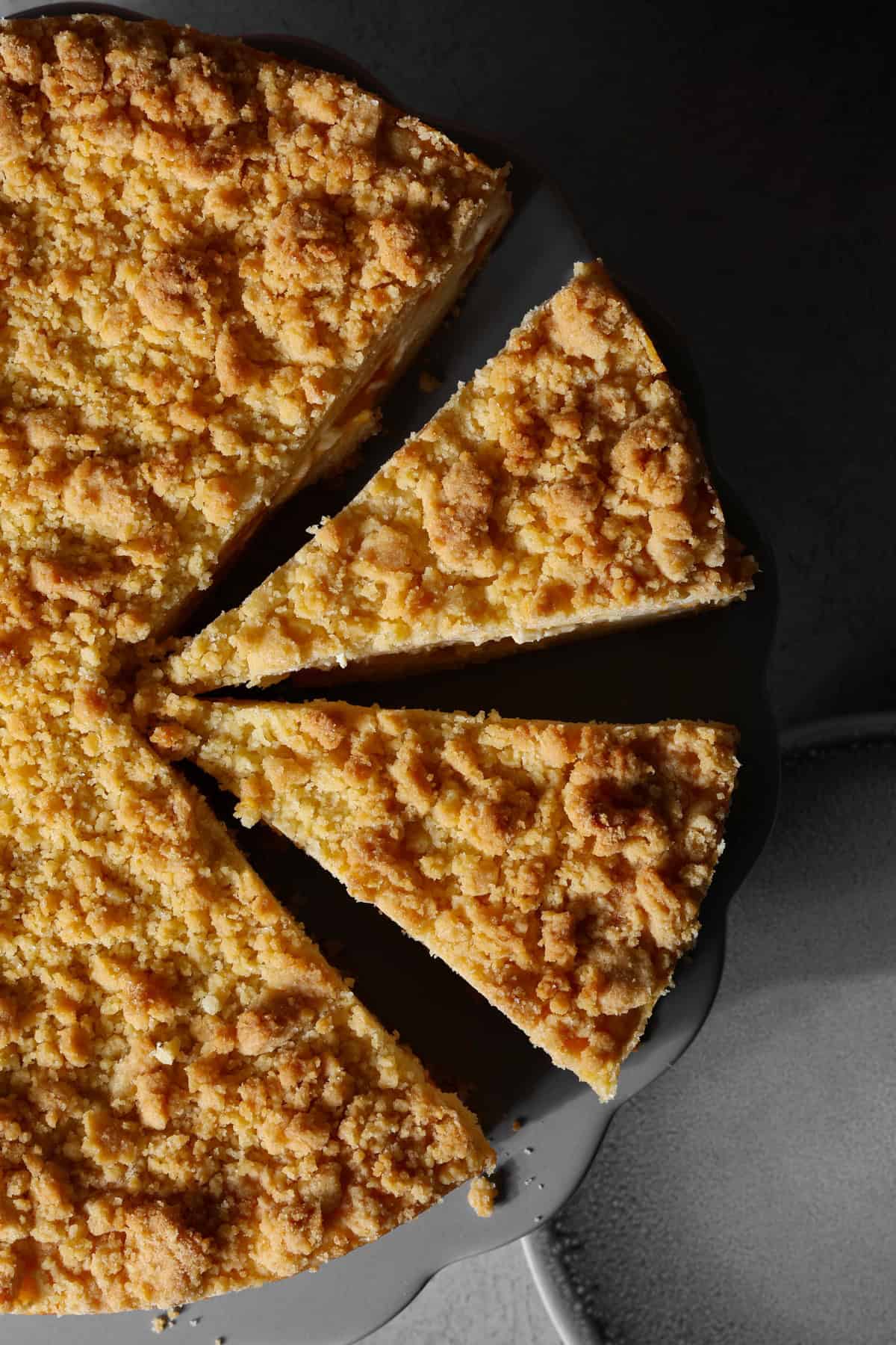 A close-up of a sliced mandarin sour cream crumb cake.