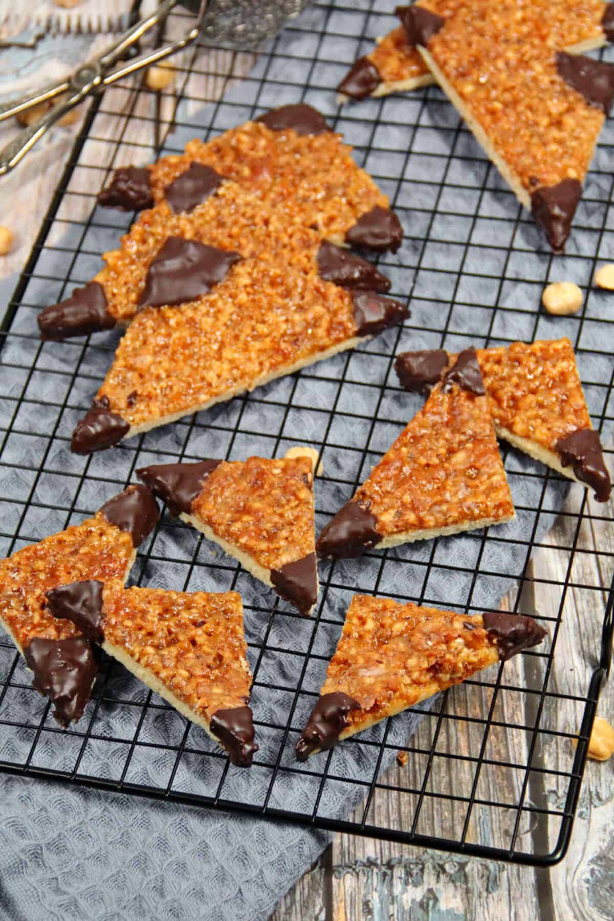 German nut triangles on a black wire cooling rack.