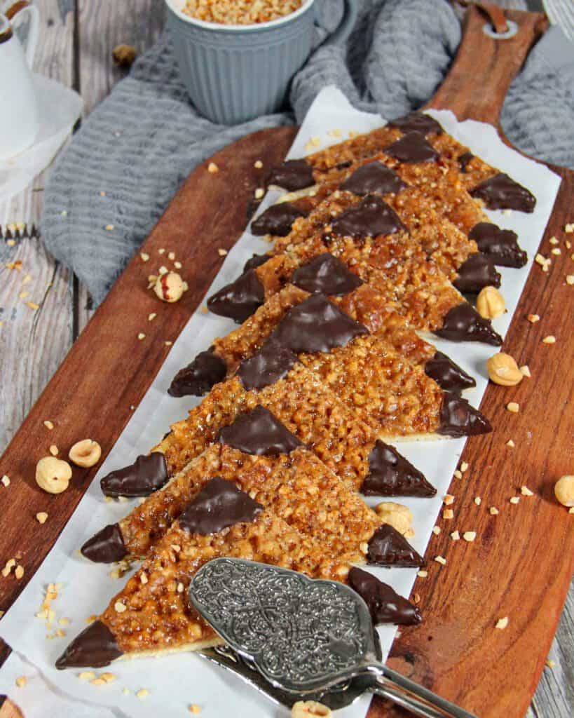A wooden serving platter with nut corners.