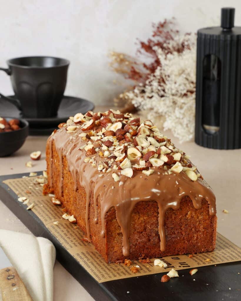 A moist nut cake with dripping chocolate glaze and coarsely chopped hazelnuts as a topping.