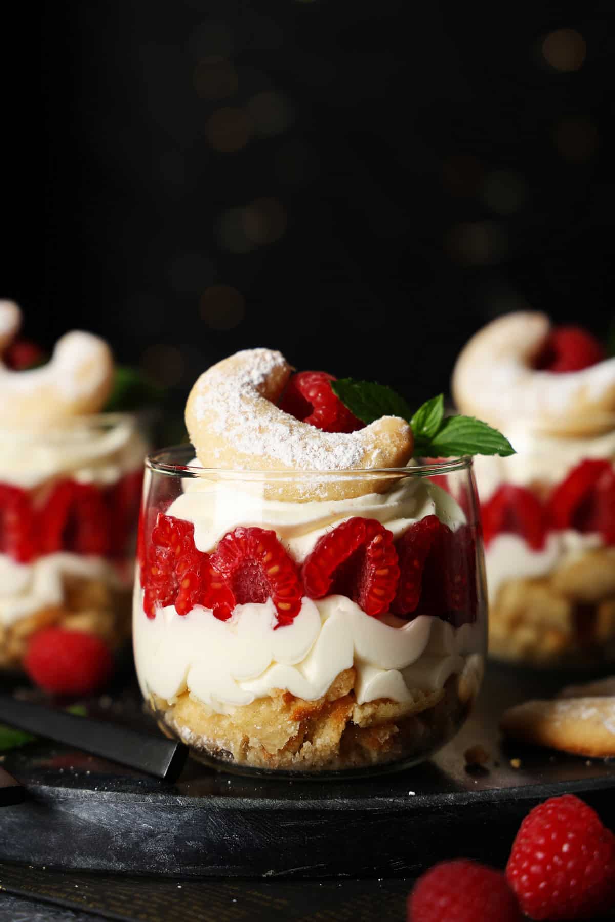 Three glasses of Vanillekipferl raspberry dessert.