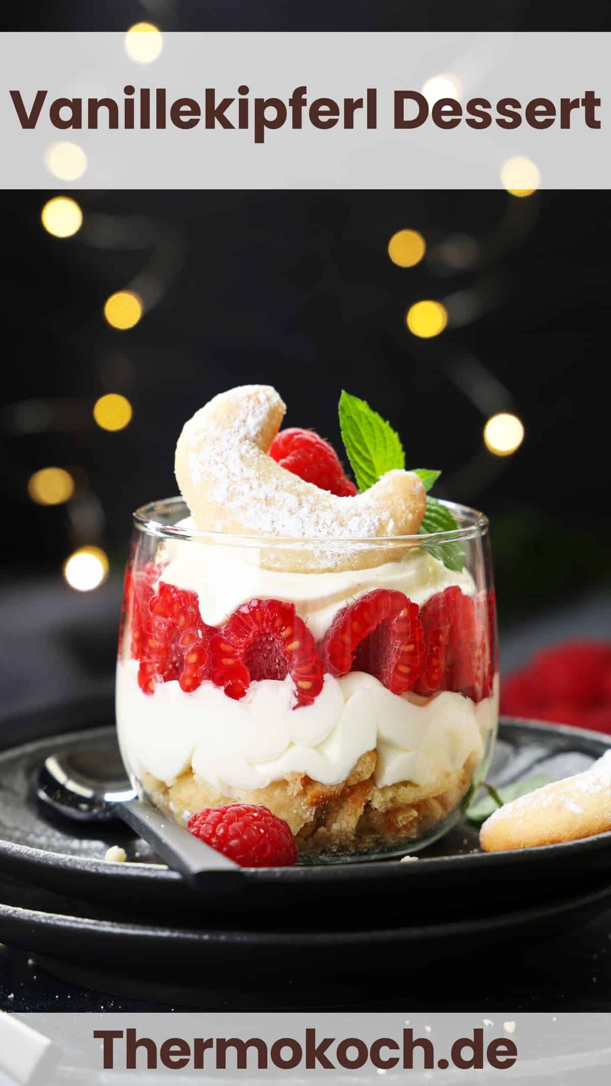 A glass filled with a layered vanilla crescent cookie and raspberry dessert.