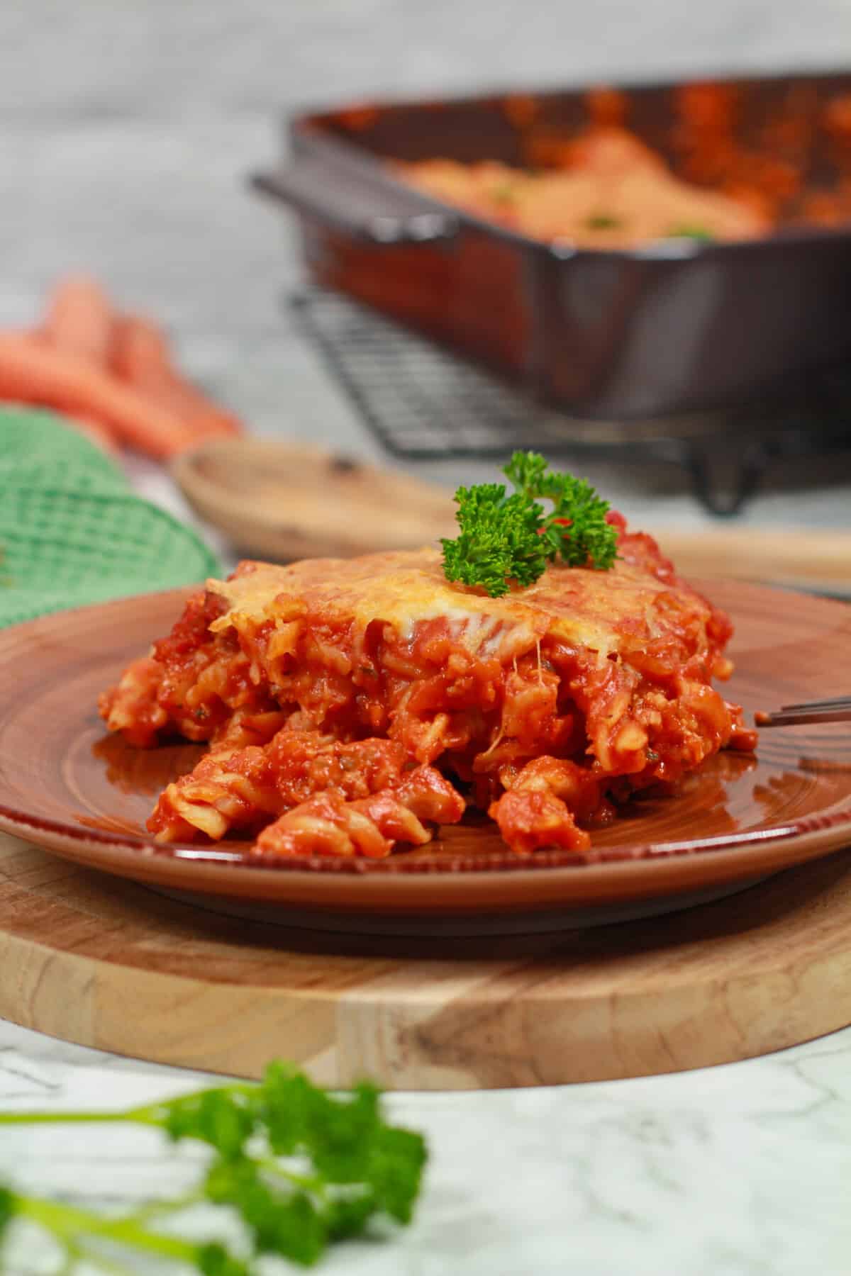 A serving of baked pasta casserole on a white plate.